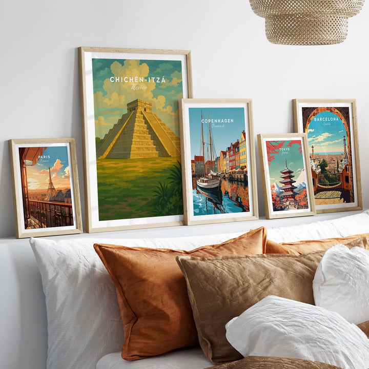 Framed travel prints of Chichén Itzá, Copenhagen, and Barcelona on a stylish wall above a cozy sofa.