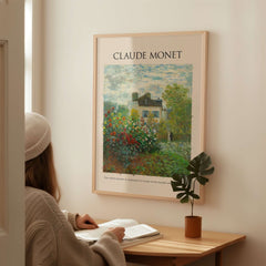 Monet Artists Garden Argenteuil Dahlias Floral Impressionist Poster Art Print displayed on a wall with a woman reading.