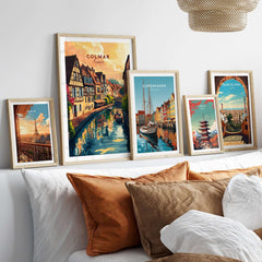 A collection of framed art prints including the Colmar Art Print, showcasing vibrant street scenes and travel posters.