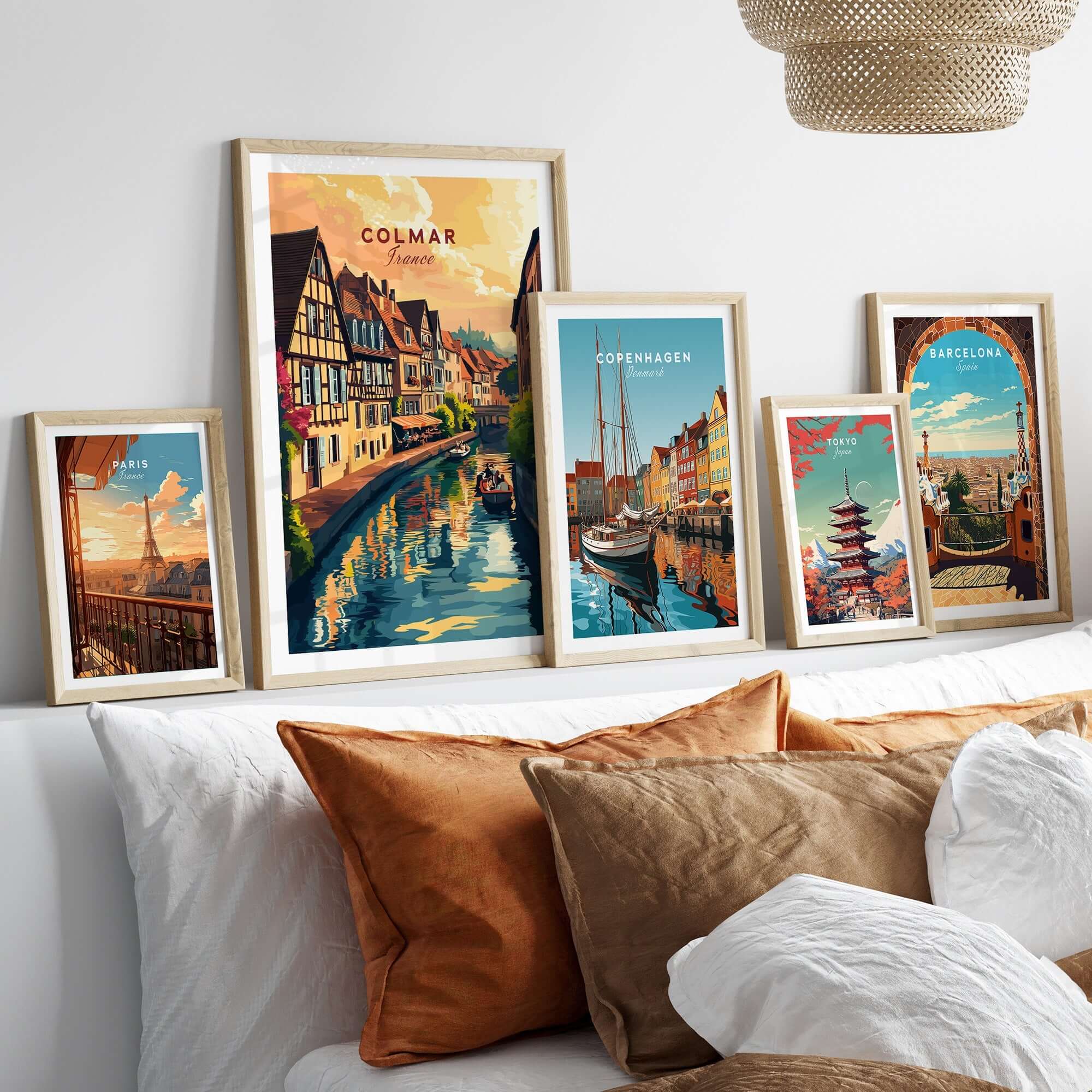 A collection of framed art prints including the Colmar Art Print, showcasing vibrant street scenes and travel posters.