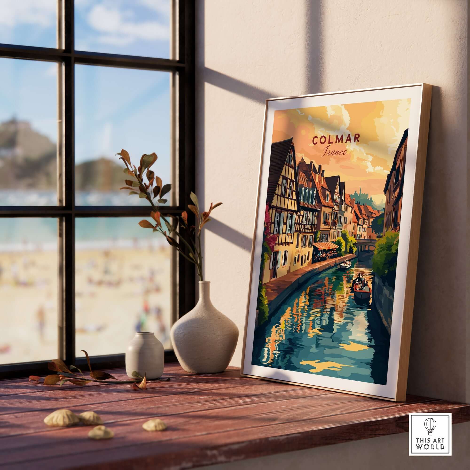 Colmar Art Print showcasing vibrant colors, framed, placed by a window with a view of a beach.