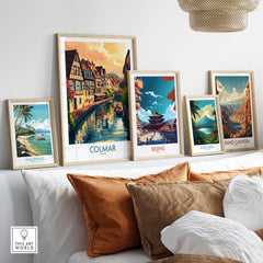 Framed travel posters including Colmar Print, showcasing scenic views of Colmar and other destinations.