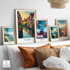 Colmar Travel Poster displayed among other travel posters in a stylish home setting with vibrant colors.