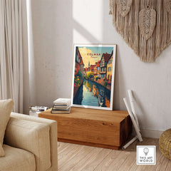Colmar Travel Print showcasing a vibrant illustration of a scenic canal and colorful buildings, perfect for home decor.