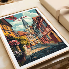 Colmar Wall Art showcasing a vibrant street scene in Colmar, France with colorful buildings and floral accents.