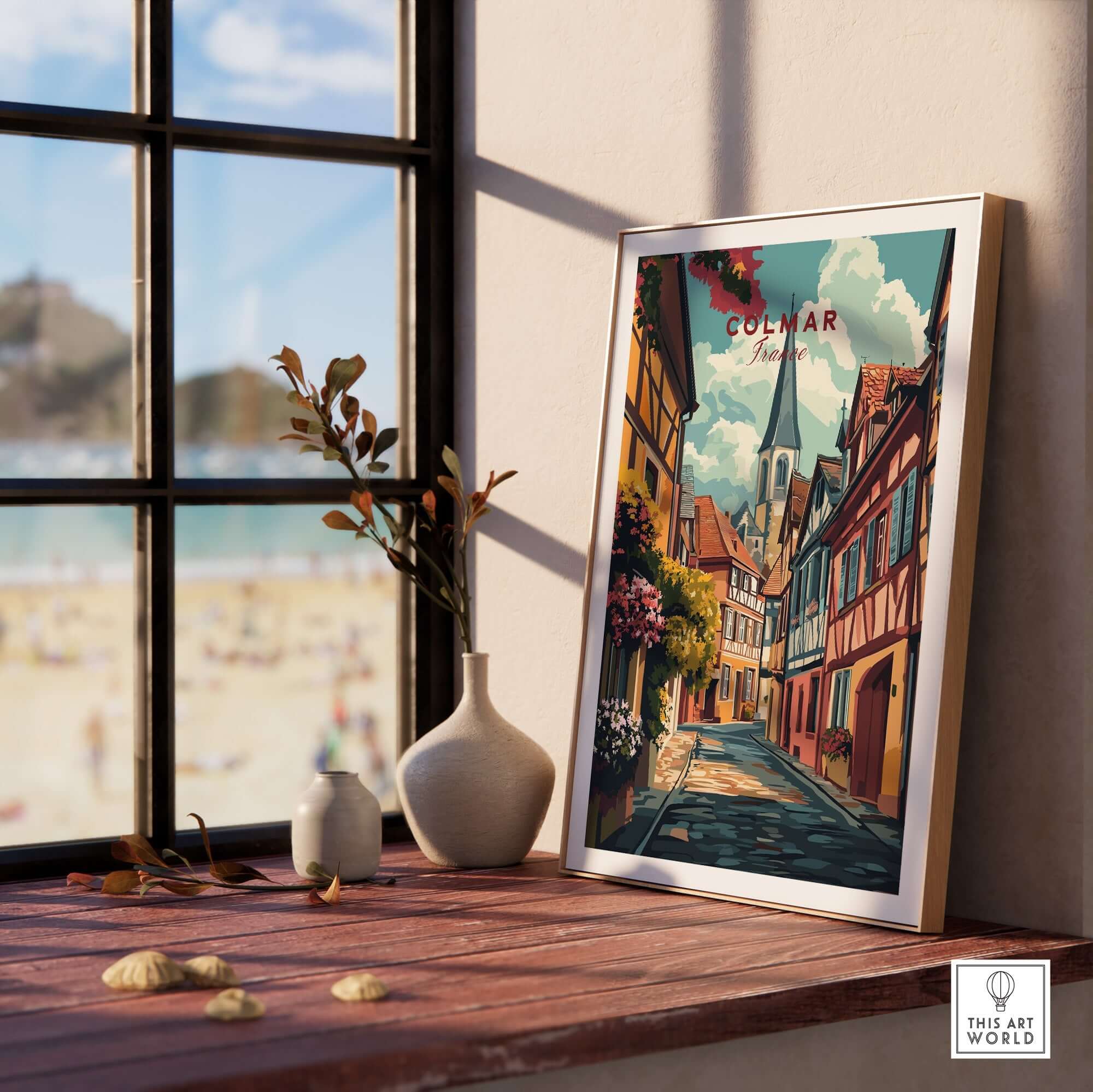 Colmar Wall Art framed on a wooden table by the window, showcasing vibrant colors and charming street scene.