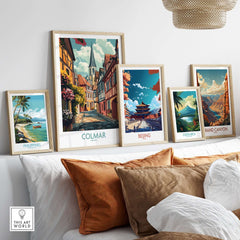 Colmar Wall Art Print displayed among other travel posters and framed artwork on a stylish shelf.