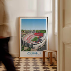 Columbus Ohio Wall Art – Collegiate Football Stadium Sports Decor displayed in a stylish room with a person walking by.