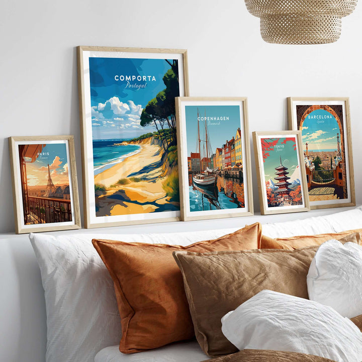 Framed coastal landscape posters including Comporta Portugal, displayed on a stylish bed with decorative pillows.