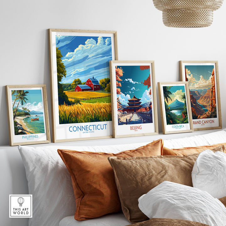 Collection of vibrant travel posters featuring Connecticut, Beijing, Costa Rica, and more, displayed on a modern couch.