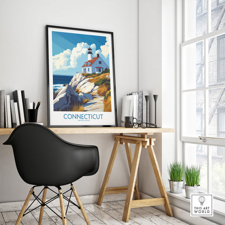 Connecticut travel poster featuring a lighthouse and coastal landscape, framed on a desk with modern decor and natural light.