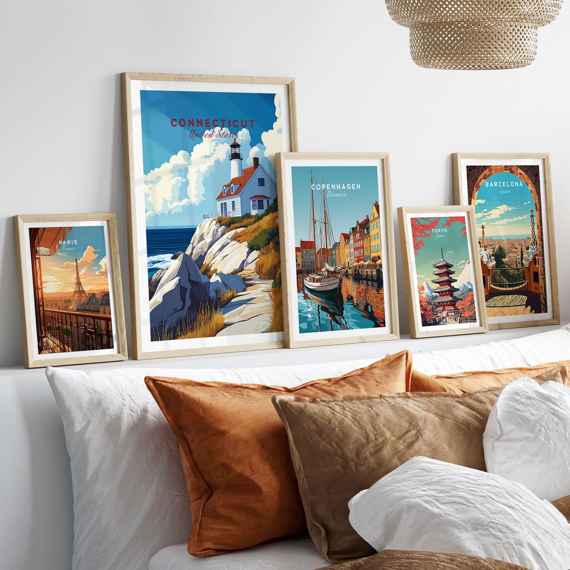 Connecticut Travel Print and other travel-themed wall art framed in a stylish home setting with decorative cushions.