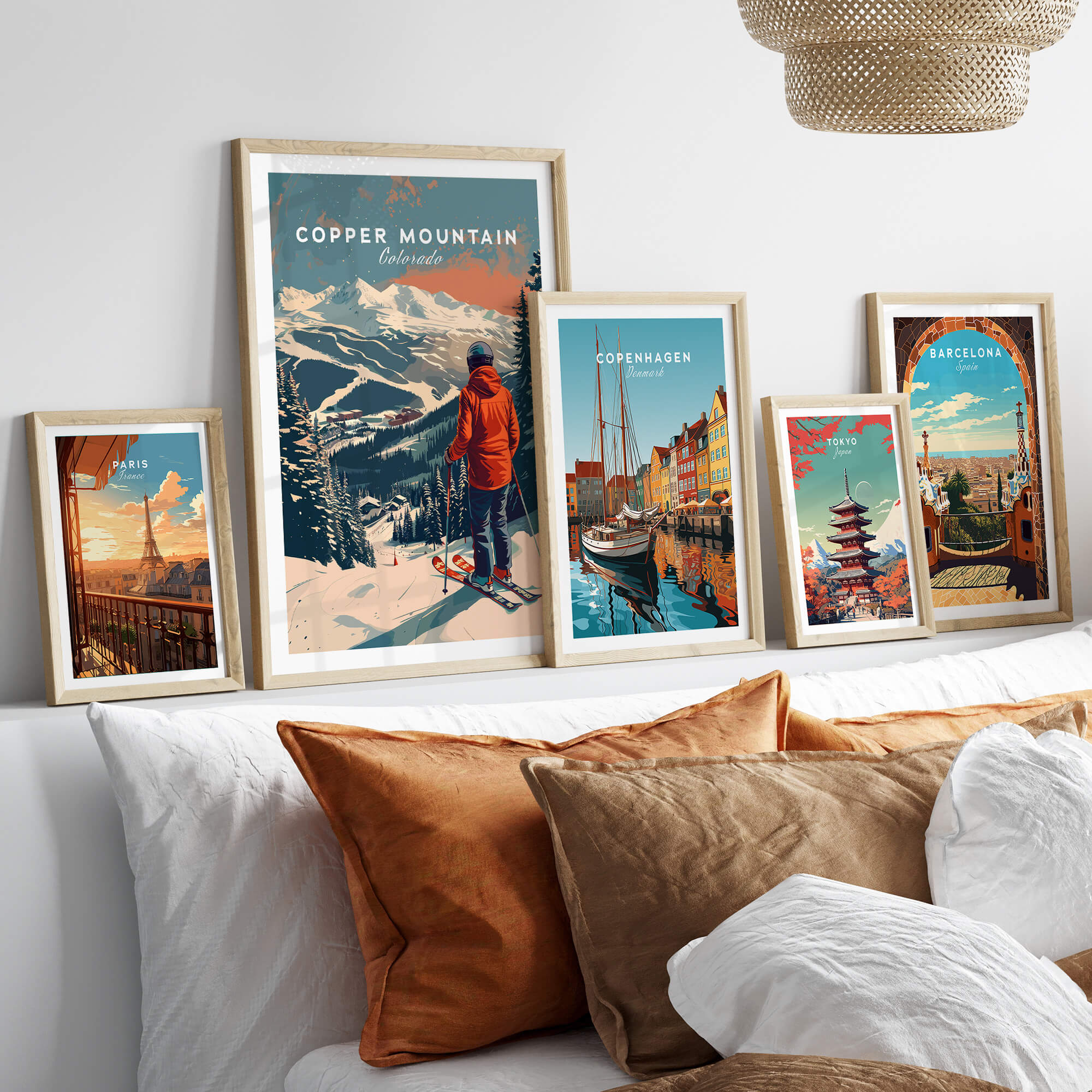 Copper Mountain Travel Poster – Skiing Into Sunset displayed among other travel posters on a stylish sofa.