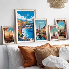 Corsica Wall Art Poster displayed among travel-themed artwork on a cozy couch setting.