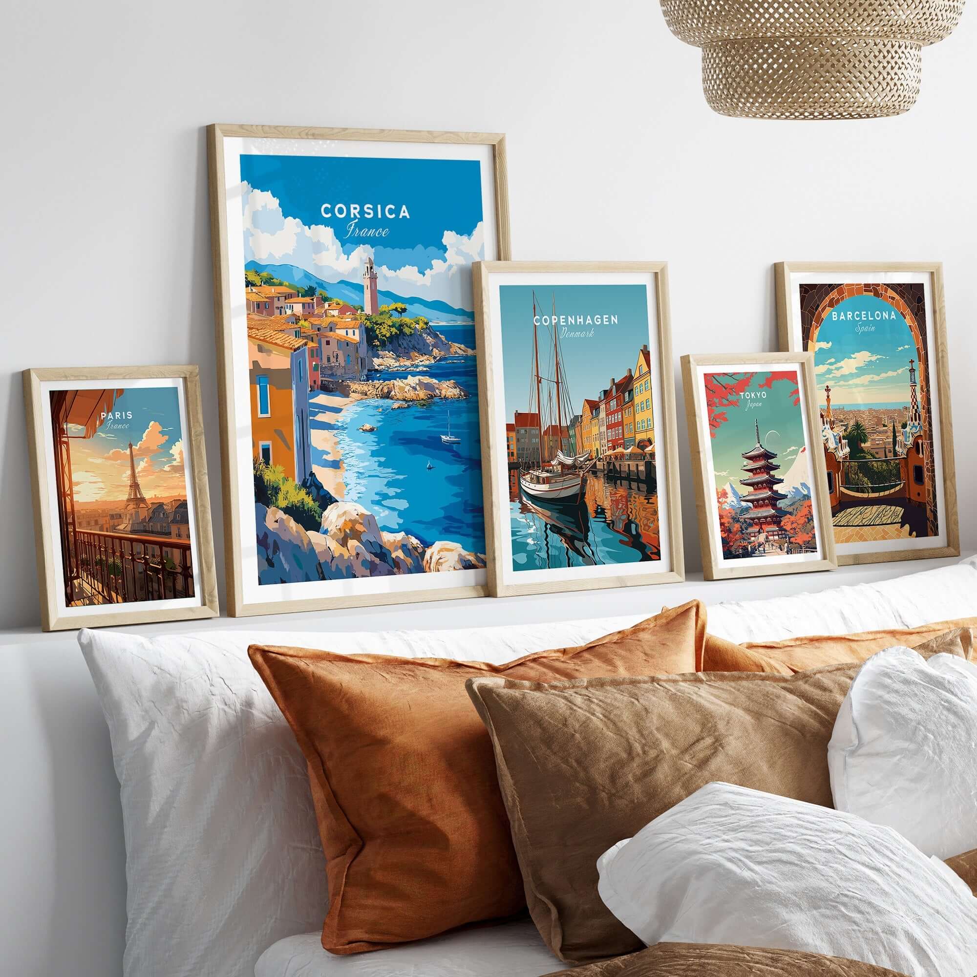 Corsica Wall Art Poster displayed among travel-themed artwork on a cozy couch setting.
