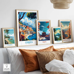 Corsica Wall Art Print displayed among other travel-themed prints on a stylish sofa.
