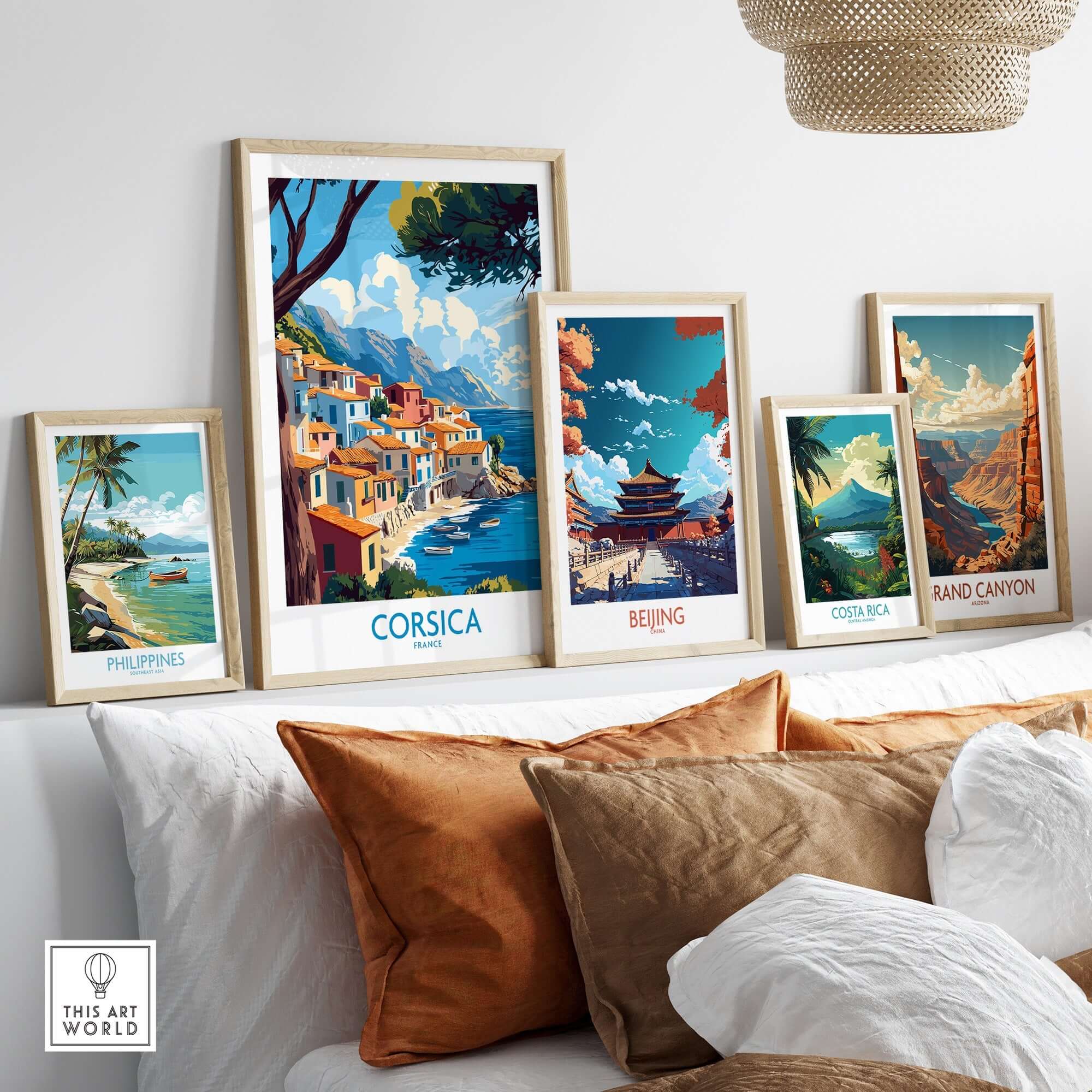 Corsica Wall Art Print displayed among other travel-themed prints on a stylish sofa.