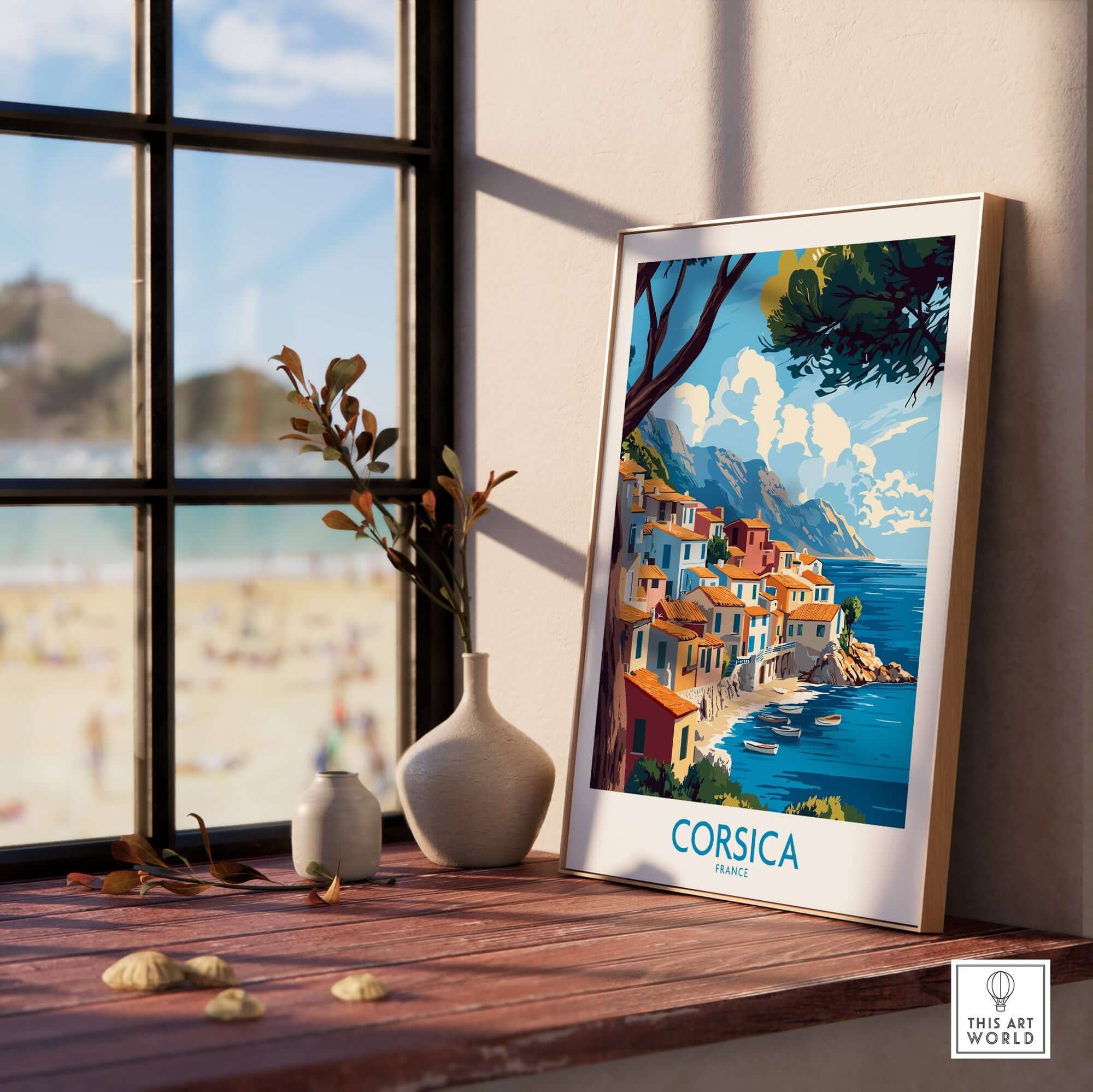 Corsica Wall Art Print displayed on a wooden shelf next to a vase, capturing the coastal beauty of Corsica.
