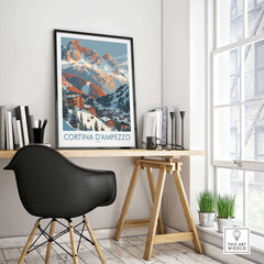 Cortina d'Ampezzo Italy print in modern office setting, featuring mountainous landscape art above a wooden desk and black chair.