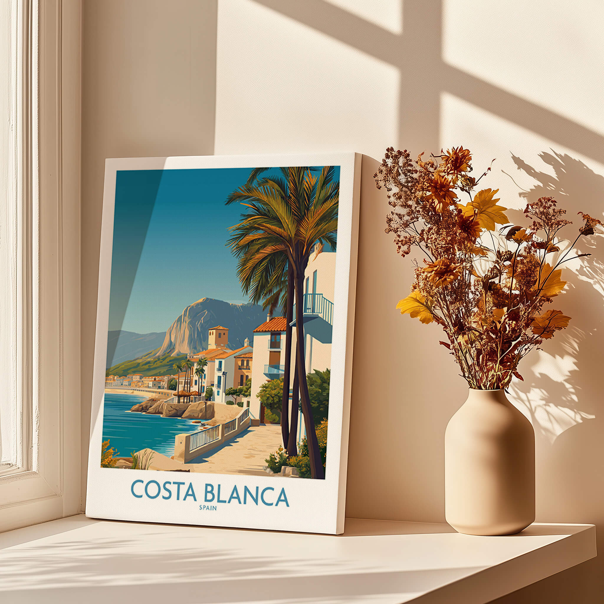 Costa Blanca Wall Art - Canvas Poster Spain displayed in a sunlit room with a vase of flowers.