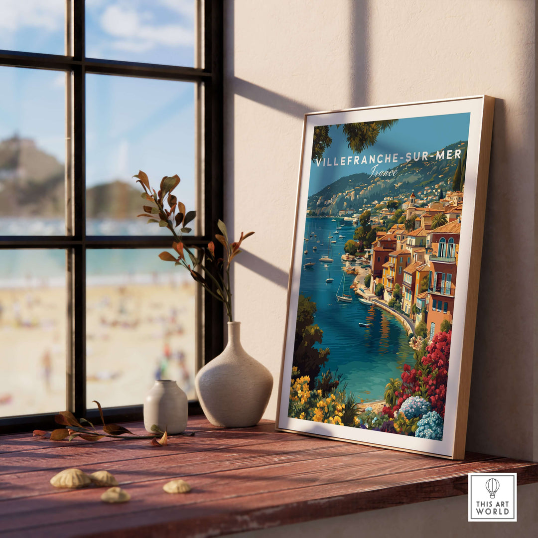 Villefranche-sur-Mer Bay poster framed on a table, showcasing coastal decor and Mediterranean charm.