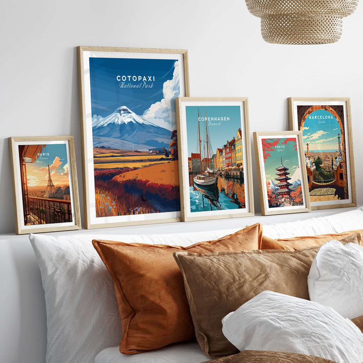 Framed Cotopaxi National Park travel print among other vibrant travel posters on a stylish bed decor.