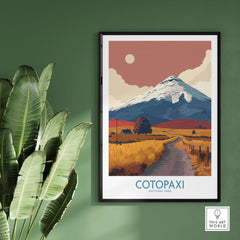 Ecuador Volcano Cotopaxi Travel Poster Road Landscape Print National Park Wall Art framed on a green wall with plants.
