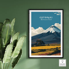 Cotopaxi National Park Travel Poster Ecuador Volcano Golden Field Print Wall Art on a green wall with leafy plants.