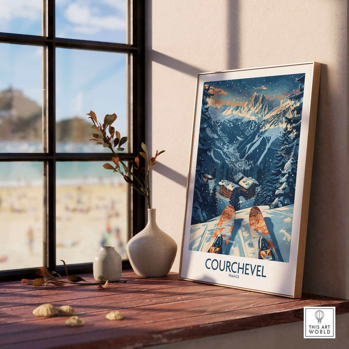 Courchevel France poster in a frame by the window with beach view, featuring snowy mountains and skis, creating a serene winter ambiance.