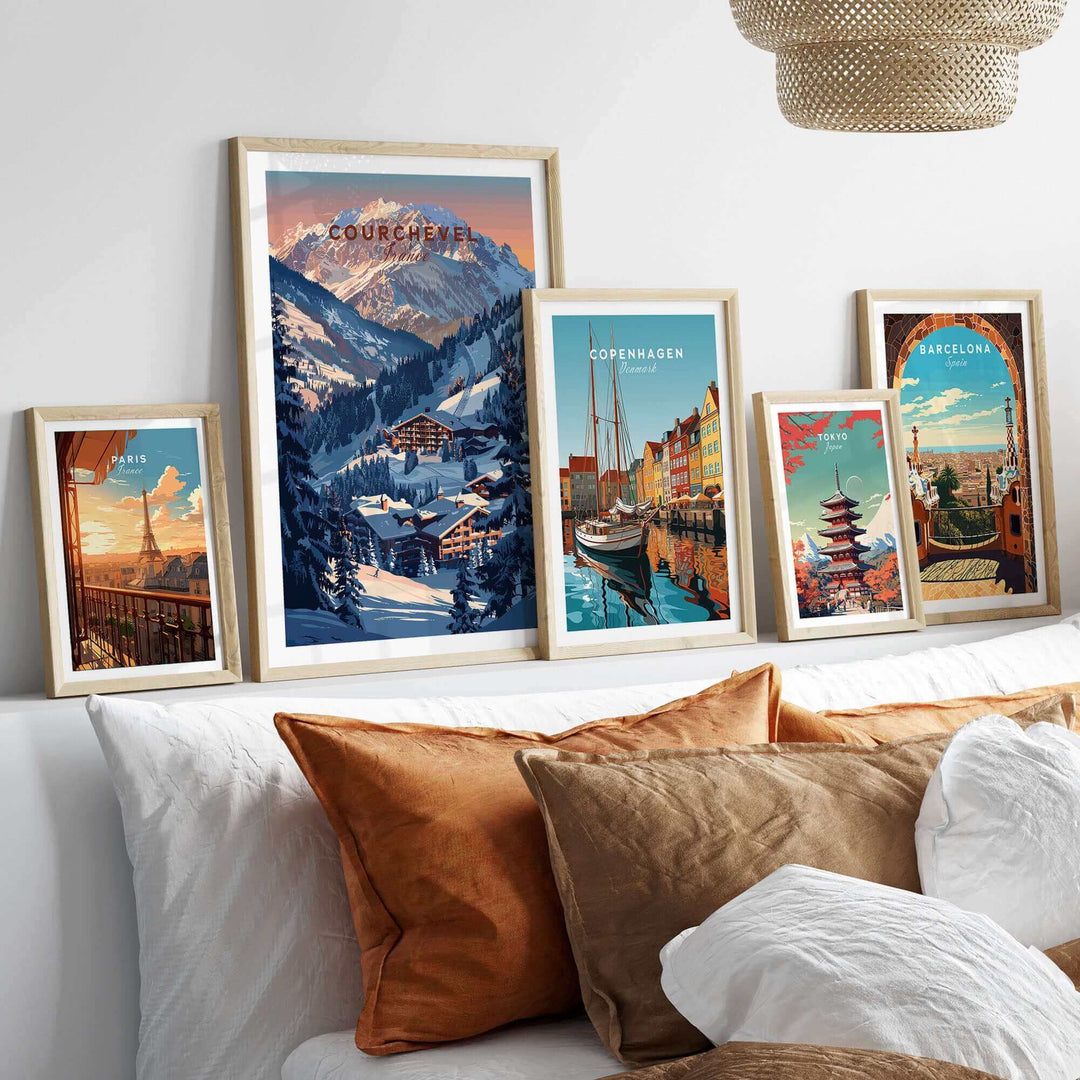 Courchevel travel poster displayed among framed city posters on a cozy bed, showcasing skiing and adventure in France.