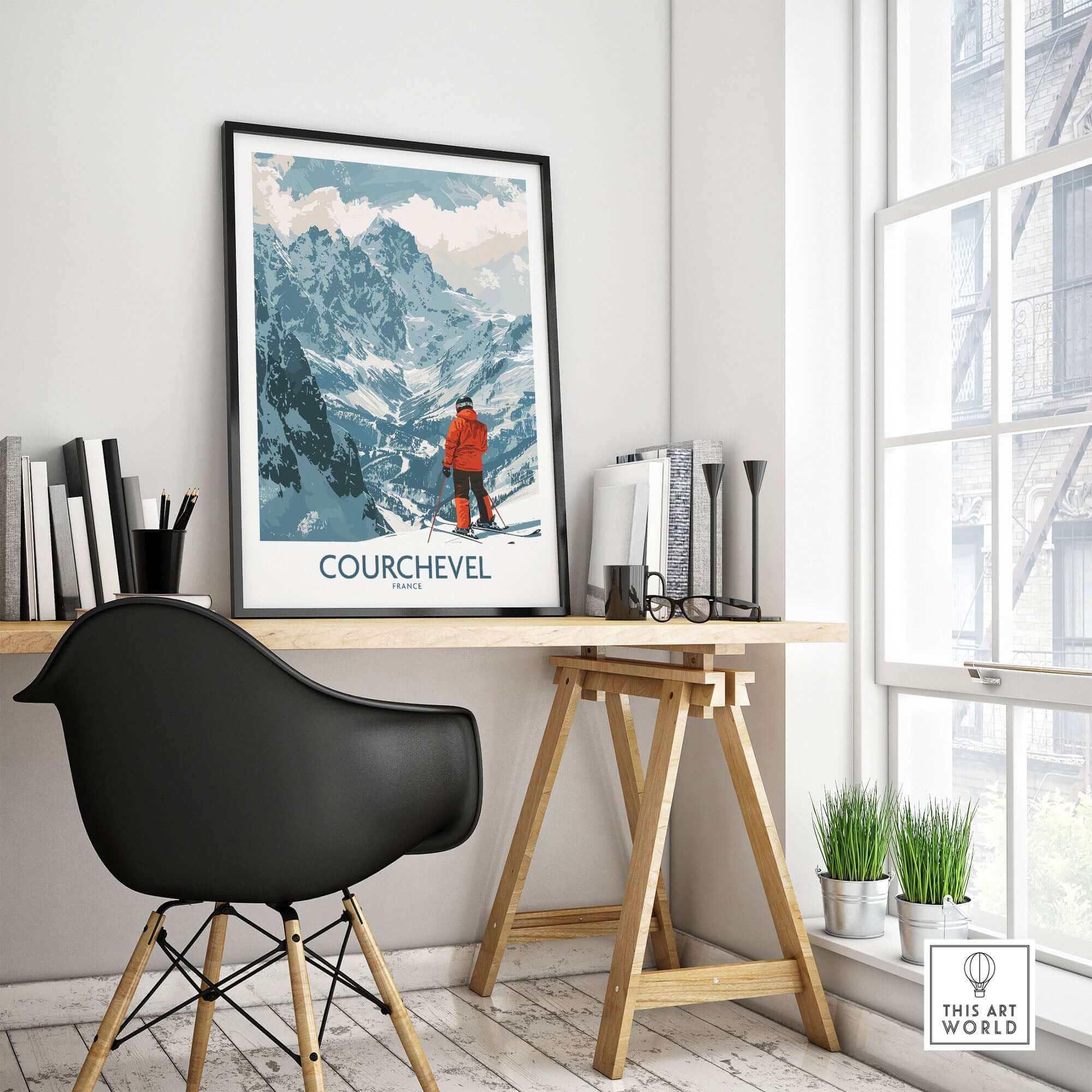 Courchevel wall art depicting a skier in red amidst snowy mountains, displayed in a modern interior with a black chair and wooden desk.