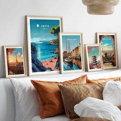Crete Poster displayed among other travel-themed wall art on a stylish couch, showcasing Mediterranean beauty.