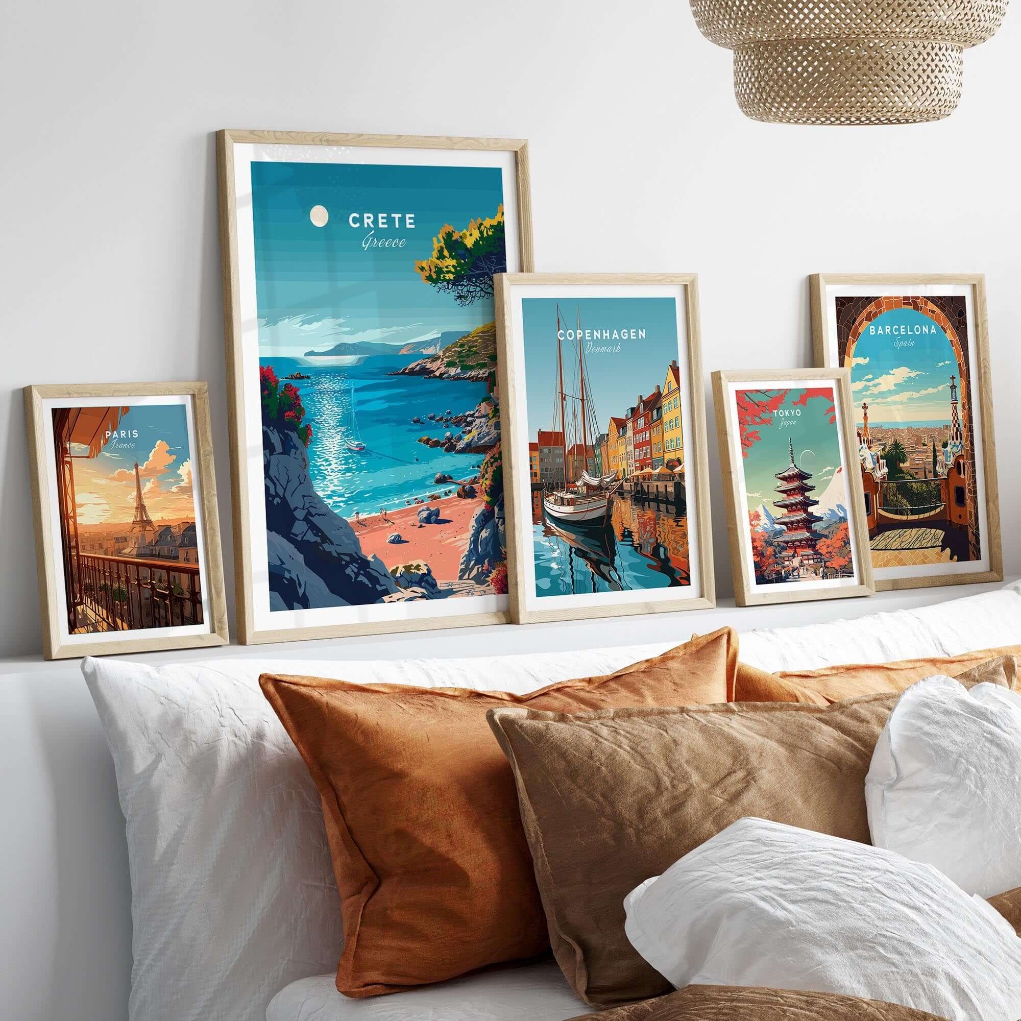 Crete Poster displayed among other travel-themed wall art on a stylish couch, showcasing Mediterranean beauty.