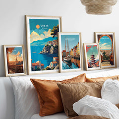 Crete Wall Art featuring beautiful Greece travel posters displayed in stylish frames on a cozy bed.