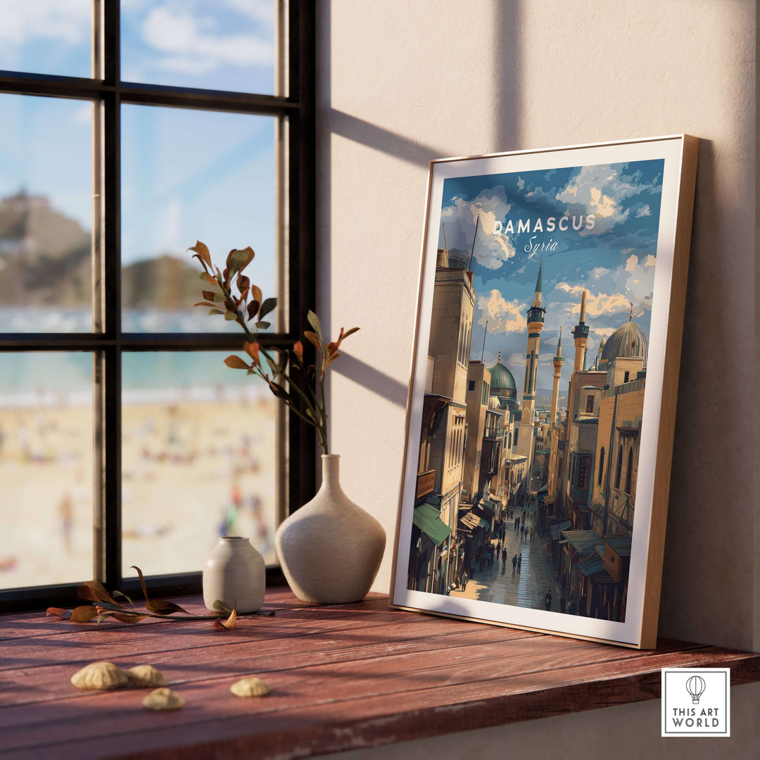 Damascus cityscape art print featuring the Umayyad Mosque, displayed on a wooden table next to plants.