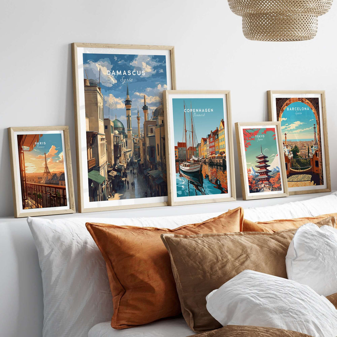Collection of cityscape art prints featuring Damascus, Copenhagen, and Barcelona in a cozy living room setting.