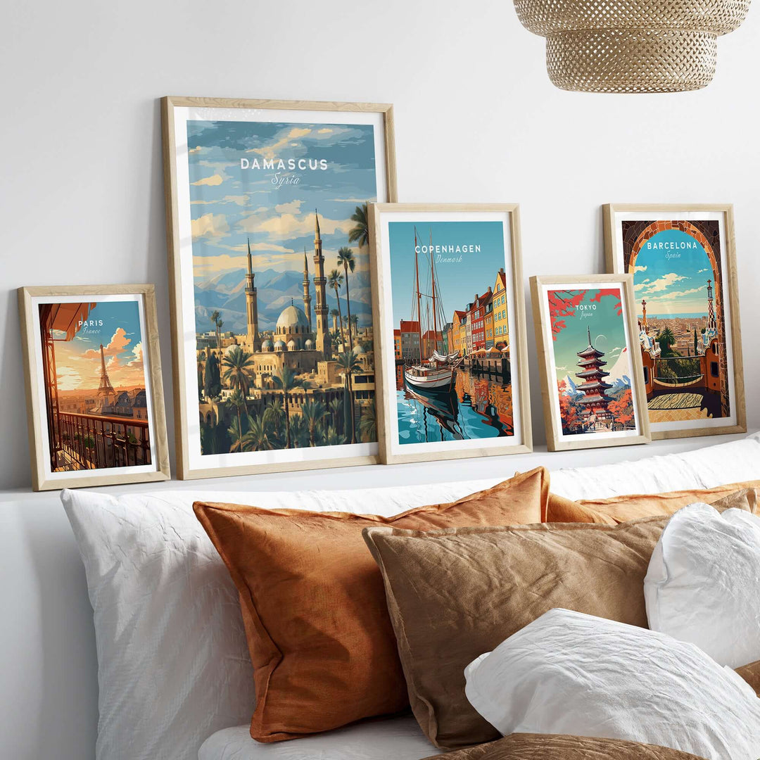 Framed travel prints of Damascus, Copenhagen, and Barcelona showcasing scenic artwork and cultural landmarks.