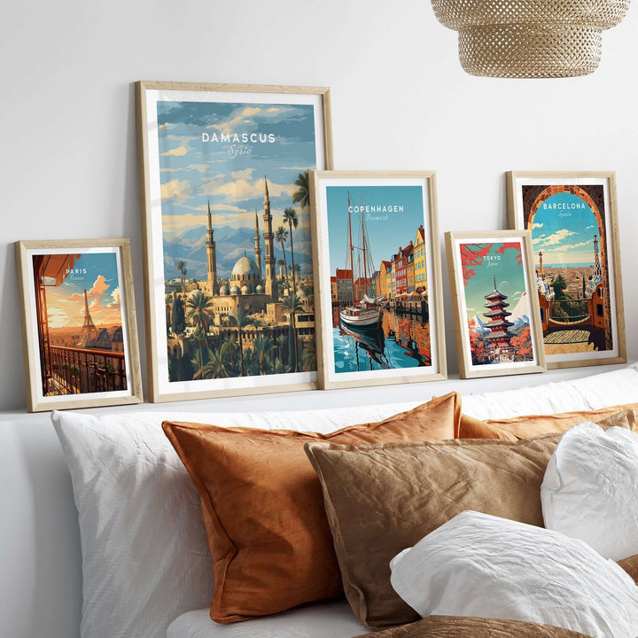 Framed travel prints of Damascus, Copenhagen, and Barcelona showcasing scenic artwork and cultural landmarks.