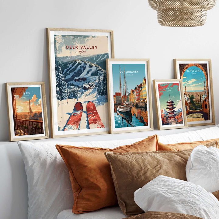 Modern living room with diverse travel posters, featuring a prominent Deer Valley ski poster in a framed collection on the couch.