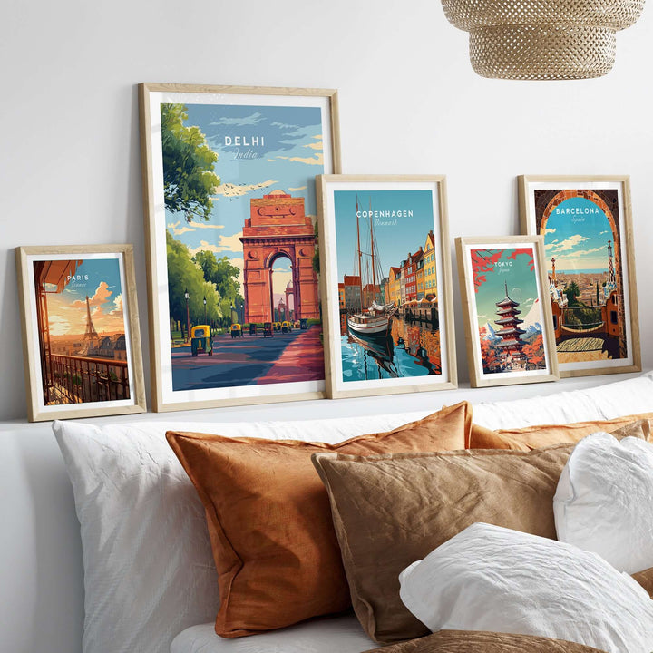 Delhi India Gate travel poster framed with cityscape art on a couch, showcasing vibrant wall decor.
