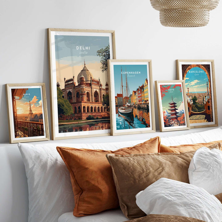 Delhi travel poster featuring Humayun's Tomb and vibrant cityscape prints on a cozy sofa.