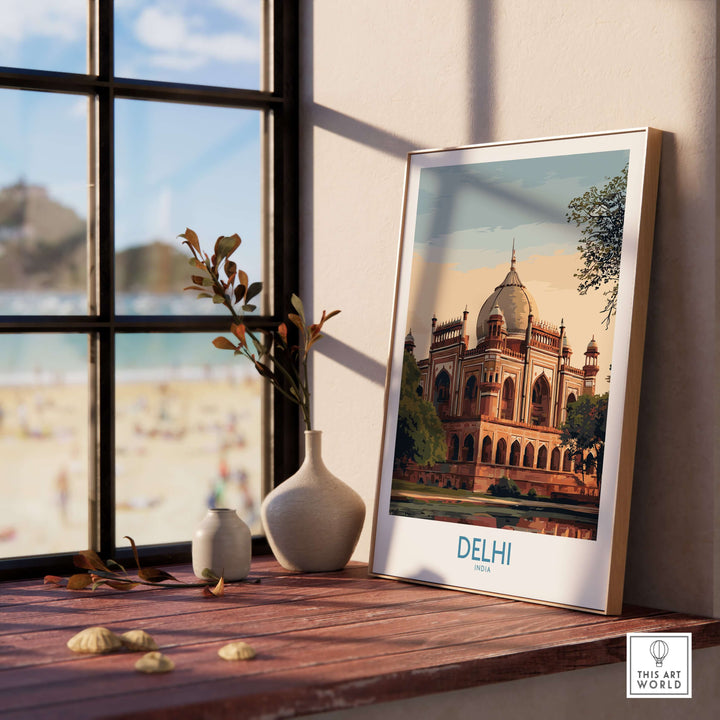 Framed print of Humayun's Tomb in Delhi, India, showcased on a wooden table near a window.