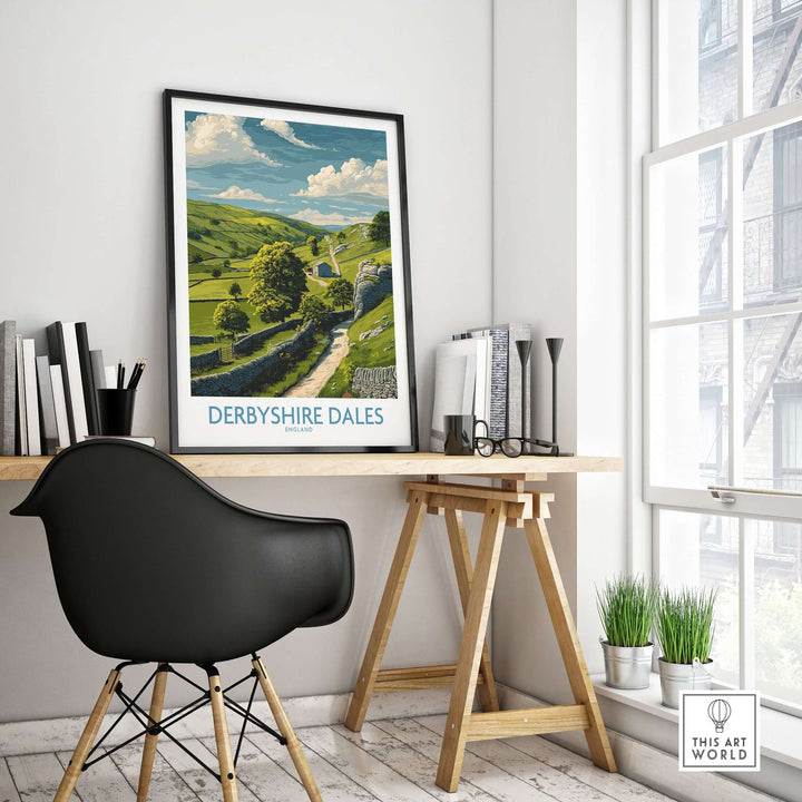 Derbyshire Dales poster displayed in a modern workspace, showcasing English landscape art of rolling hills.