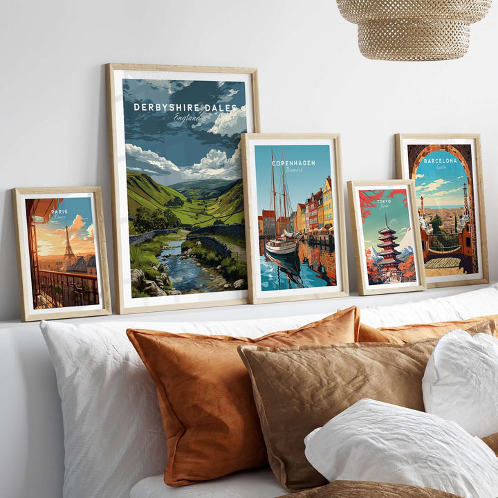 Stylish display of Derbyshire Dales and international city wall art prints on a cozy bed.