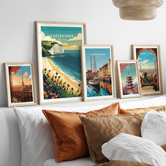 Eastbourne Wall Art featuring coastal and city landscapes in framed prints on a stylish bedroom wall.