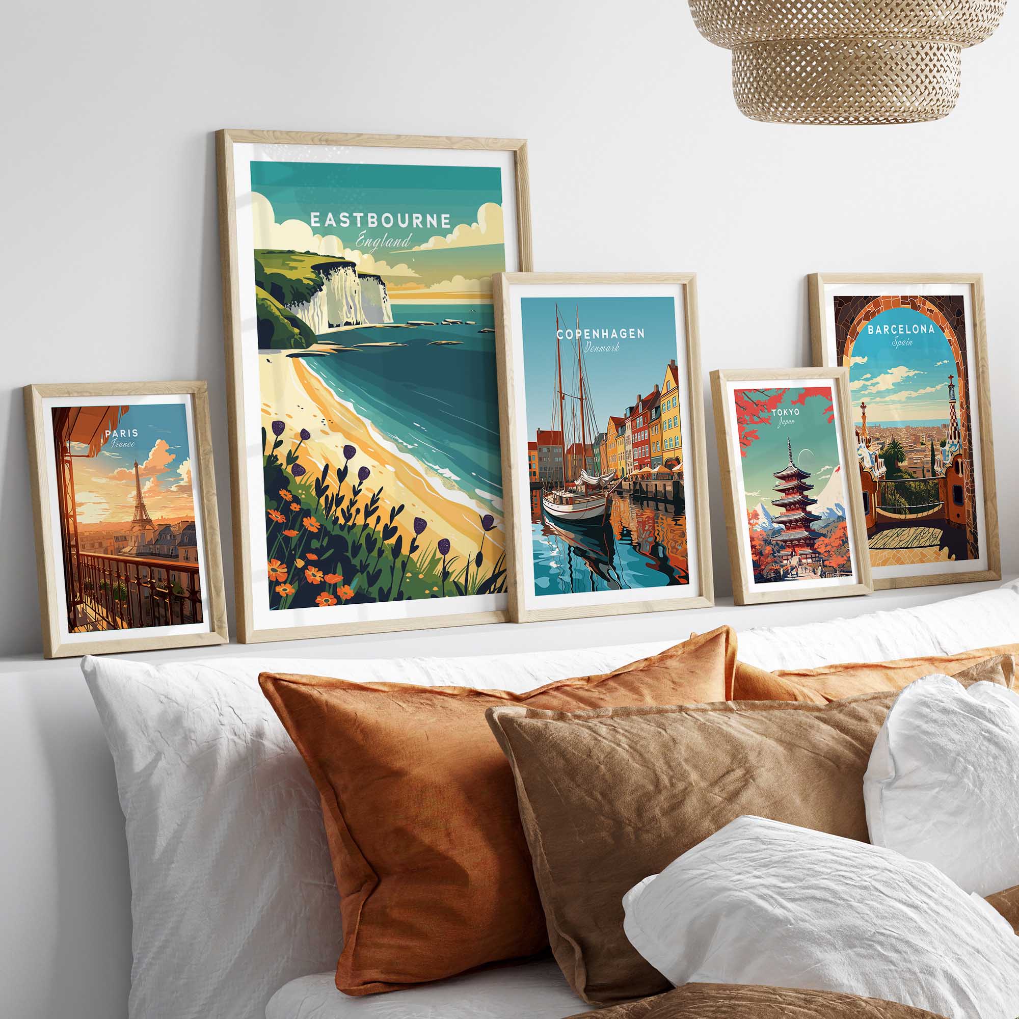 Eastbourne Wall Art featuring coastal and city landscapes in framed prints on a stylish bedroom wall.