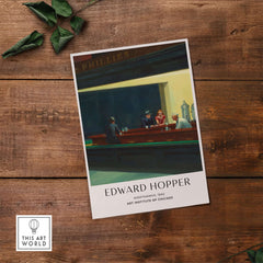 Edward Hopper Nighthawks 1942 Iconic Diner Art Print AIC Poster displayed on a wooden surface.