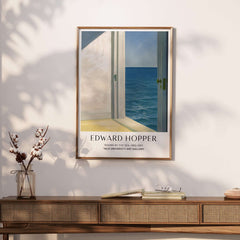 Edward Hopper Rooms by the Sea 1951 Yale University Art Print Poster framed on a wall above a wooden table.