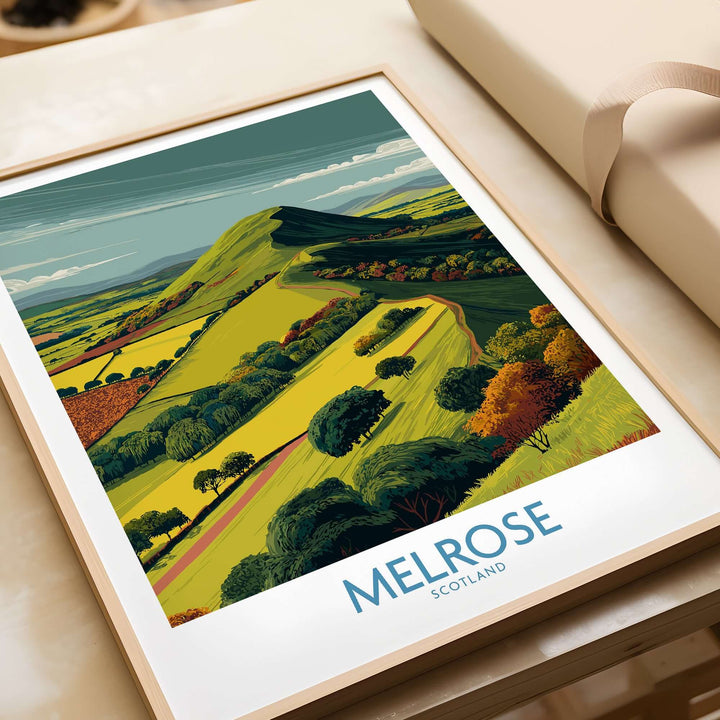 Modern travel print of Eildon Hills, Melrose in Scotland, showcasing vibrant green hills and autumn trees.