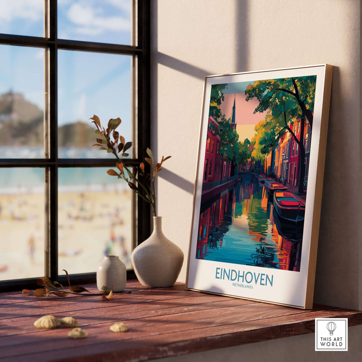 Eindhoven Art Print | Urban Sunset Reflections Poster displayed on a wooden table by a window with a view.